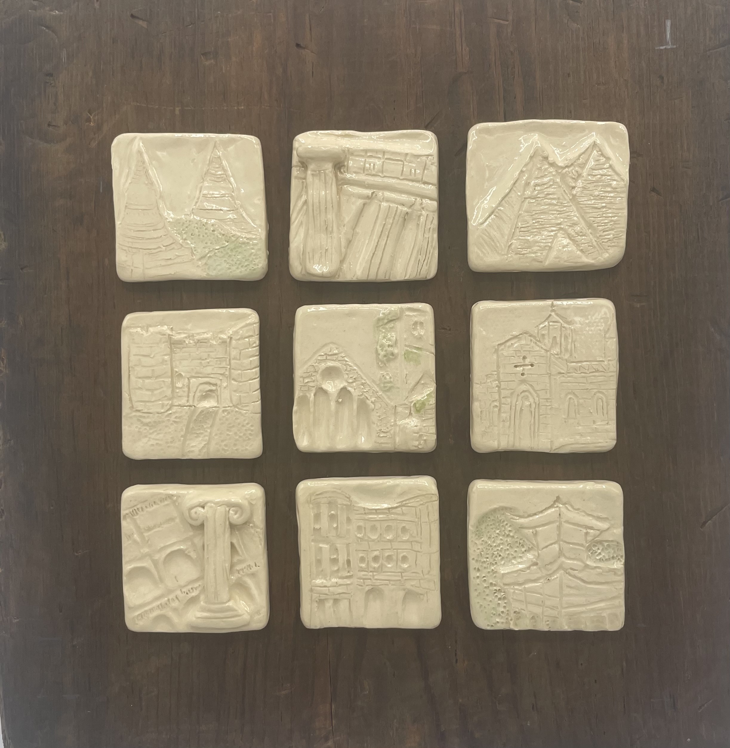 series of nine clay squares engraved with global landmarks